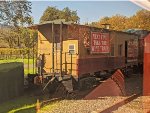 "Next Time Take the Wine Train" promotional bay window caboose displayed on the siding